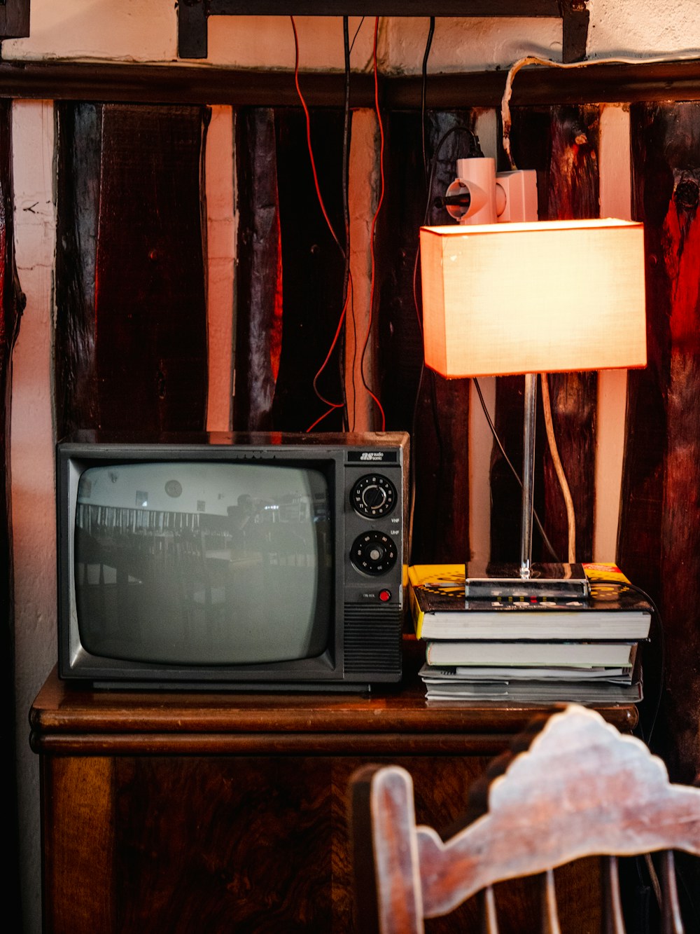 Vintage television on a wooden table beside a lamp
